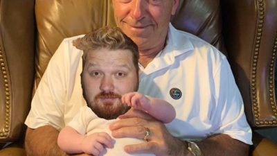 Jason's face photoshopped onto the body a baby being held by nick saban
