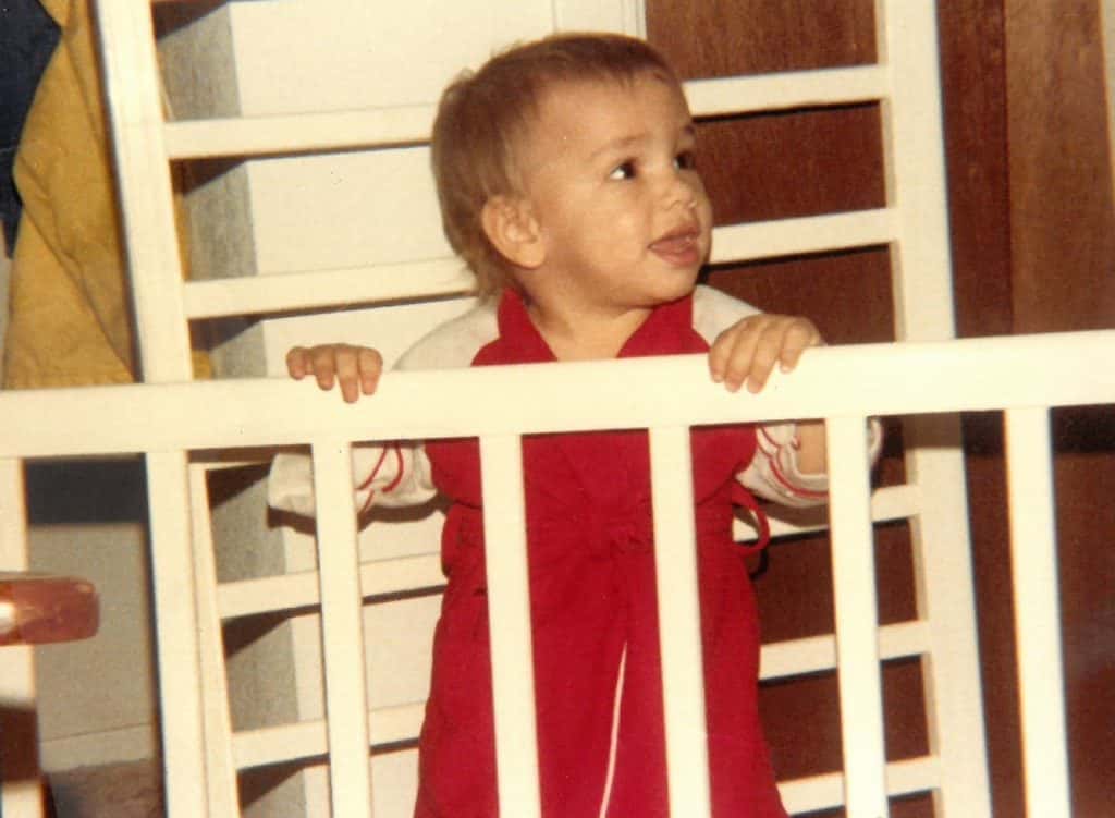 baby nick standing in a crib