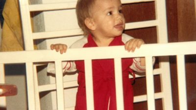 baby nick standing in a crib