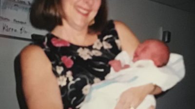 katy's mom holding her as a baby