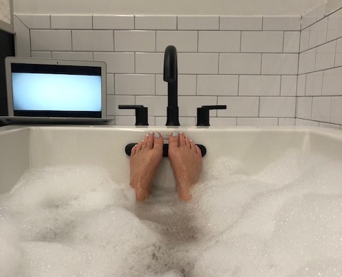 pov shot of deb's feet in a bubble bath