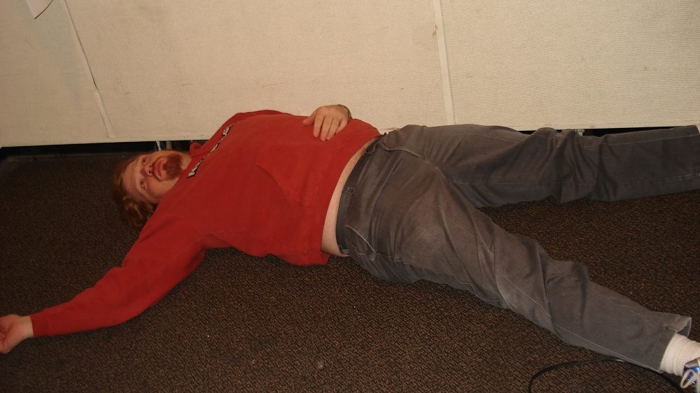 jason laying on the studio floor staring up at the ceiling