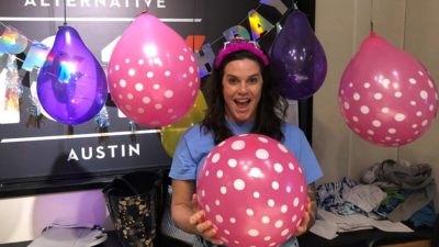 deb in the studio surrounded by birthday ballons