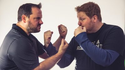 promotional photo of Jason and Nick facing off with their dukes up