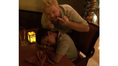 Jason flipping the bird at his nephew aiden who fell asleep at a restaurant table