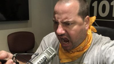 producer nick yelling into a microphone in the studio