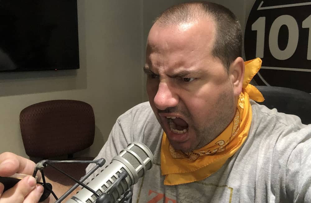 producer nick yelling into a microphone in the studio