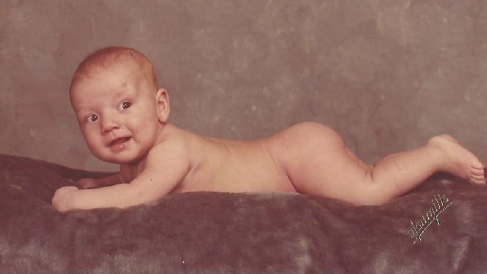 baby jason lying naked on the rug