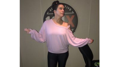 deb showing off her pink sweater that was named the c of the week