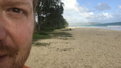 selfie of half of jason's face in front of a hawaiian beach