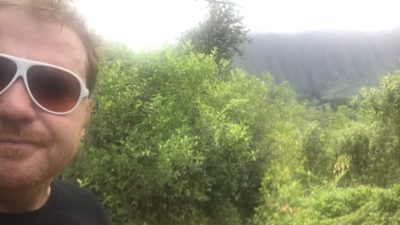 jason taking a selfie in front of some lush Hawaiian vegetation