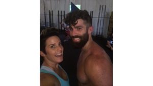 Jeff wearing no shirt and a birthday hat with deb