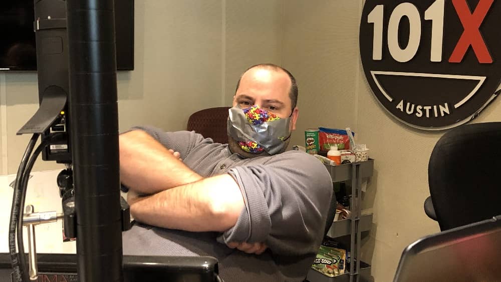 producer nick with his arms crossed and duct tape over his mouth