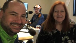 nick and jason's mom taking a studio selfie with jason in the background