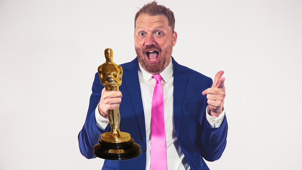 photo of jason in a suit with an academy award photoshopped into his hand