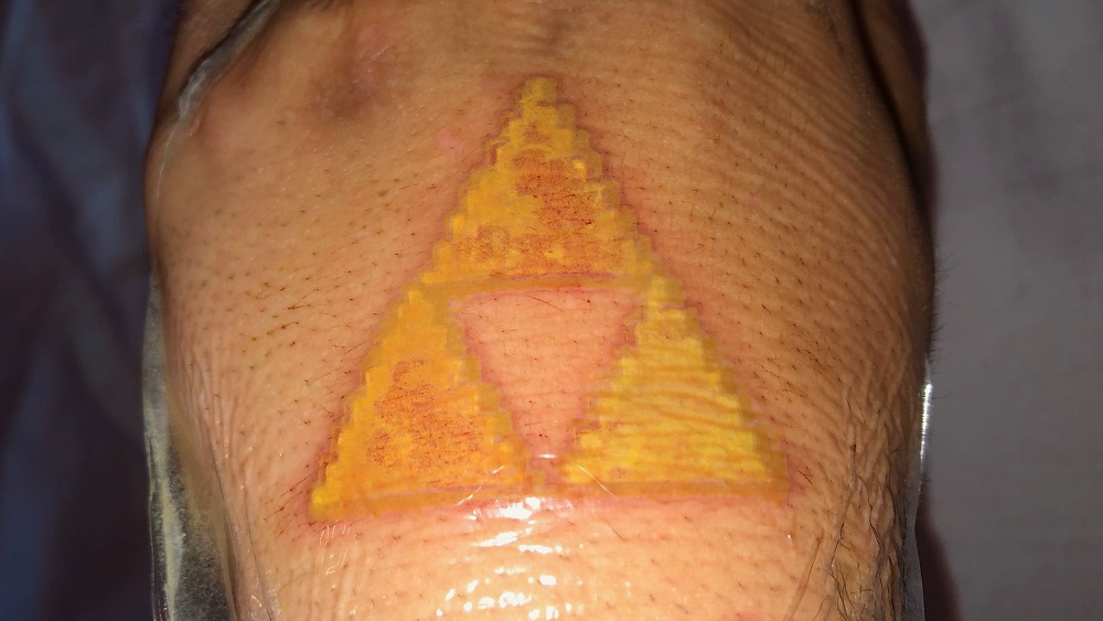 nick's new legend of zelda triforce tattoo that he got on his hand