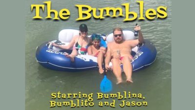 Jason and his girlfriend and her son floating on the lake, with "The Bumbles" photoshopped onto it
