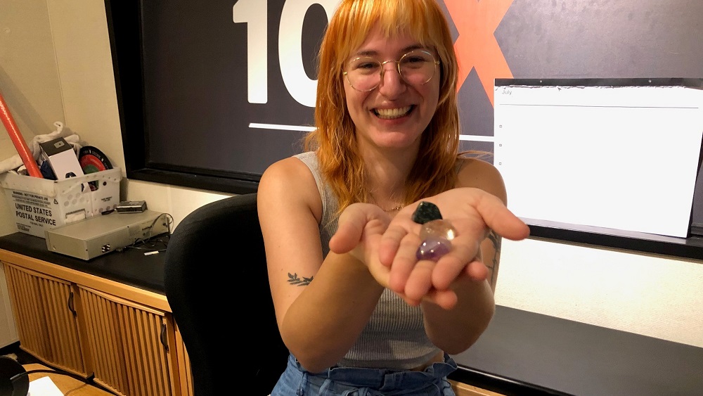 emily in studio holding crystals that have been charged with moon energy