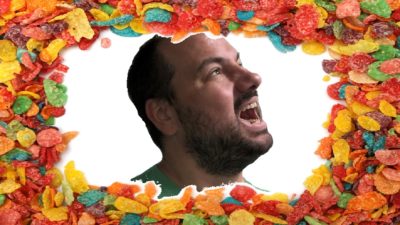 nick's face photoshopped onto a background of fruity pebbles cereal