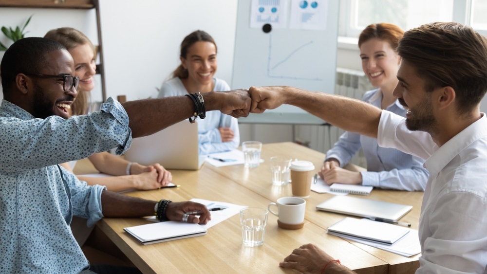 stock photo of office workers fisting