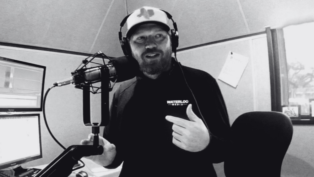 Jason talking on the radio in black and white