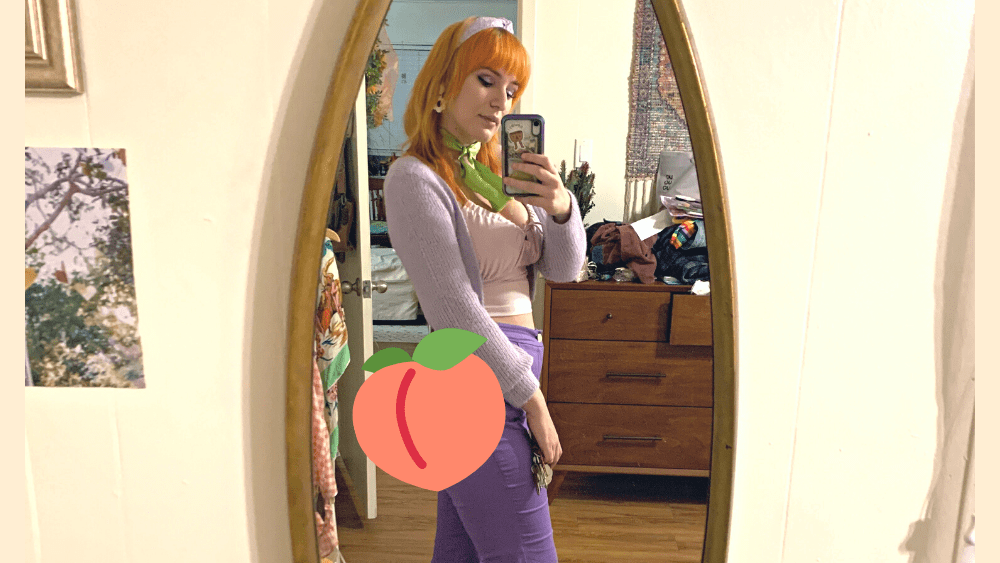 Emily mirror photo with a peach over her backsideb