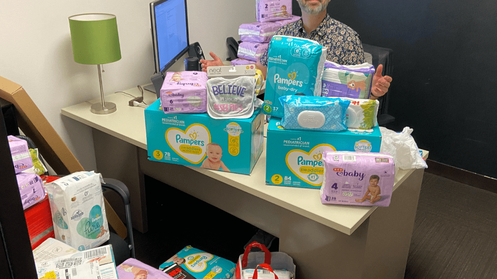 Dylan with diapers at his desk