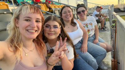 Emily and her three friends at an AG Rugby game