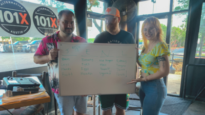 Nick, Jason, and Emily holding up a sign with the picks for the body parts