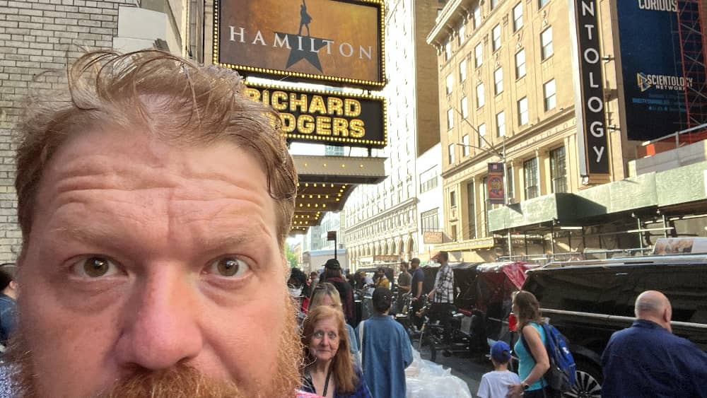 jason's face in front of the hamilton marquee