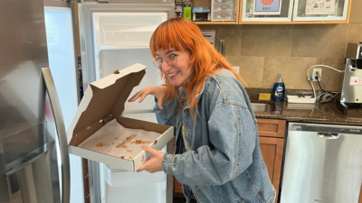 Emily looking sneaky and grabbing the last slice of pizza out of the fridge