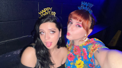 Emily and her friend on NYE making a kiss face