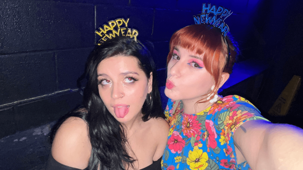 Emily and her friend on NYE making a kiss face