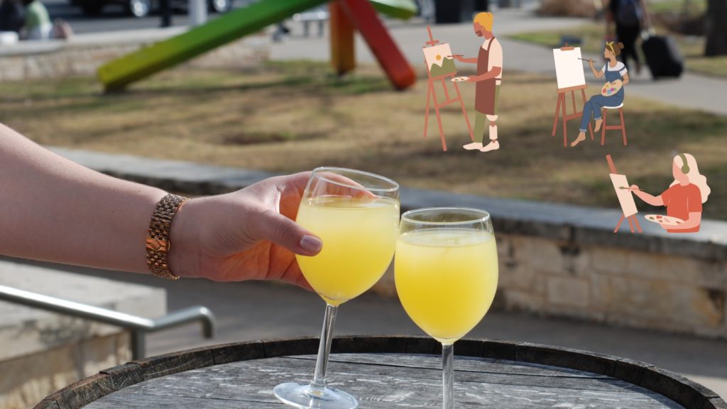 Picture of two wine glasses cheersing outside.