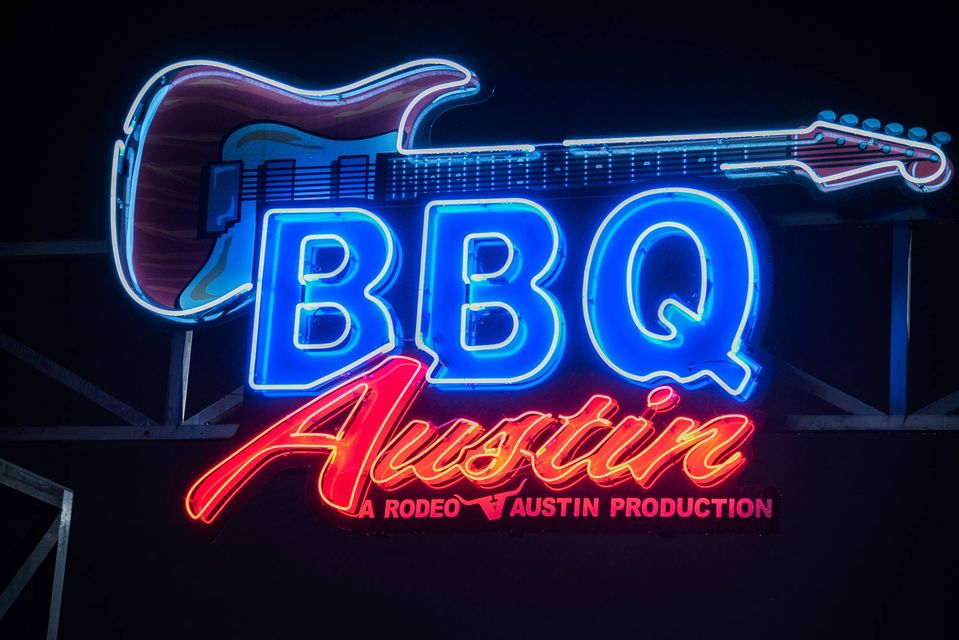 A neon sign spelling out "BBQ Austin".