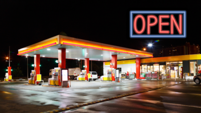 Gas station lit up at night with an "open" sign. Photo from Shutterstock