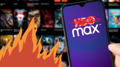 Phone with HBO Max on it with the HBO hastily crossed out, over HBO Max catalog & animated fire. Credit to Miguel Lagoa & Shutterstock.
