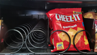Cheez-Its in a vending machine next to an empty vending machine slot