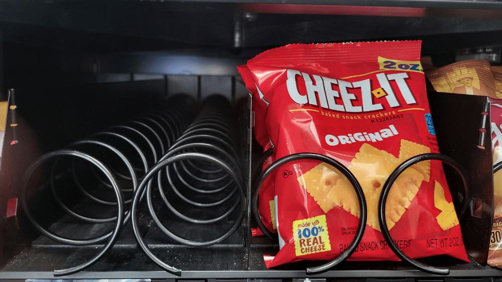 Cheez-Its in a vending machine next to an empty vending machine slot