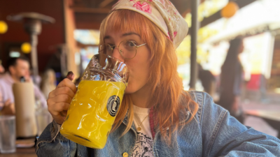 Emily drinking a massive mug of orange juice.