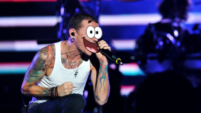Chester Bennington of Linkin Park performing at a concert with Patrick Star's face photoshopped over his.