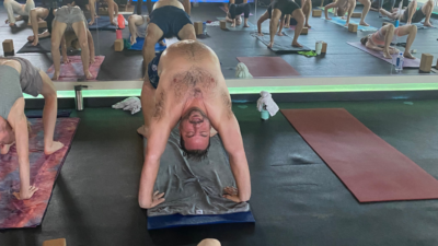 A picture of Nick, very sweaty, in a yoga studio doing yoga.