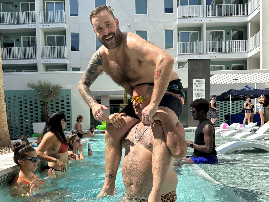 nick and cj morgan playing chicken at the 101x pool party