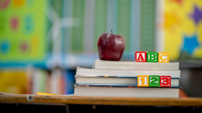 Image provided by shutterstock. ABC blocks on top of books with an apple