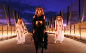 three women on a bridge looking spooky
