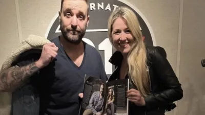 CJ Morgan and Madeline Hollern holding an Austin Monthly magazine