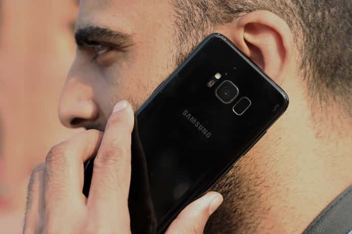Man talking on black cell phone. (Photo by Nasir Kachroo/NurPhoto via Getty Images)