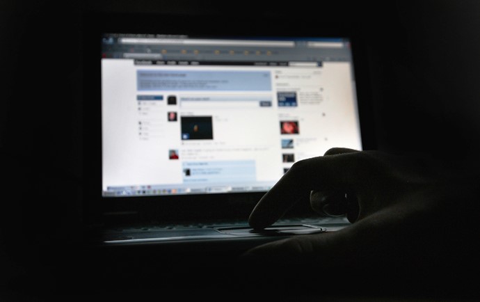 silhouette of hand on computer keyboard in front of monitor (Dan Kitwood/Getty)