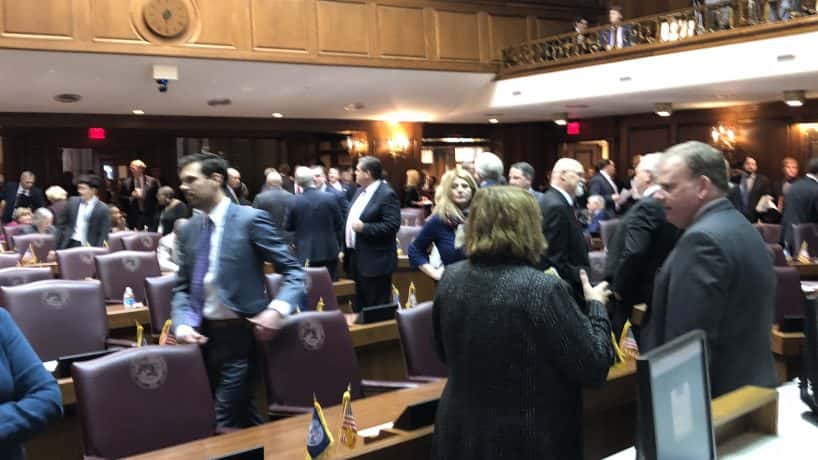Legislators get ready to take their seats in the House chamber at the start of the 2019 session