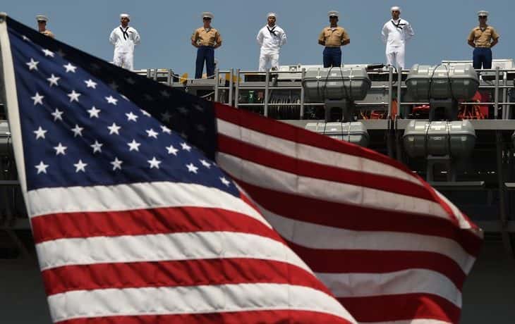 Veterans looking upon the American Flag (PHOTO: Timothy A. Clary / Getty Images)